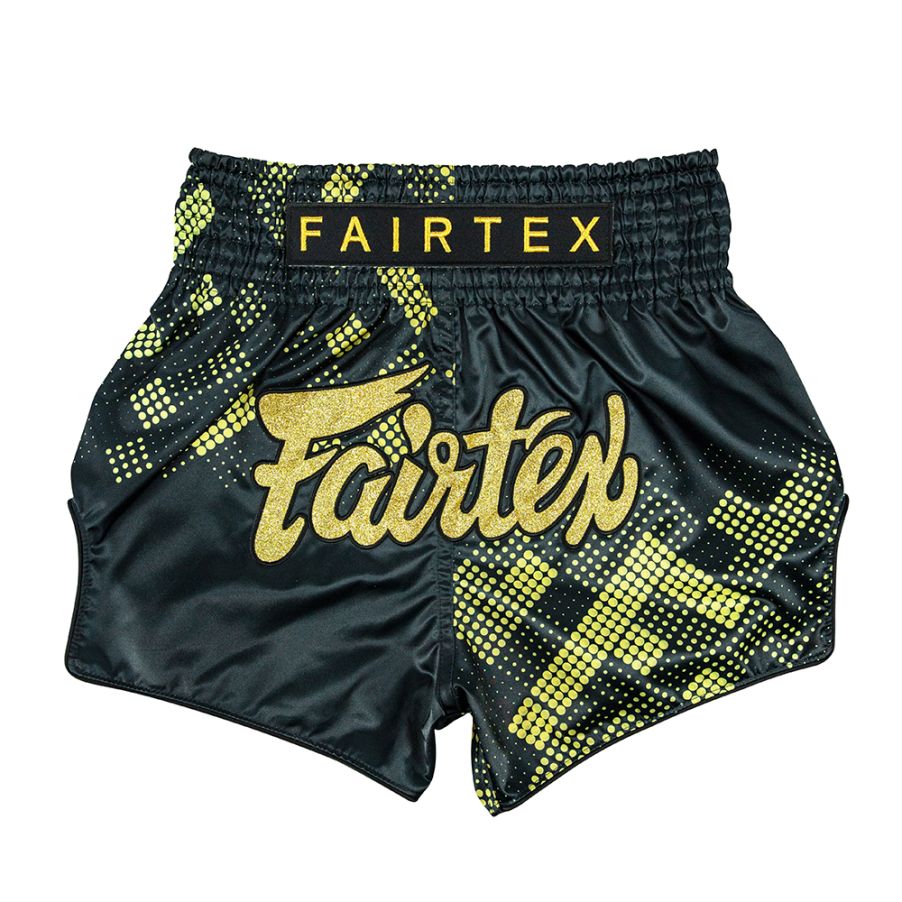 Black and yellow Fairtex Muay Thai shorts on a white background