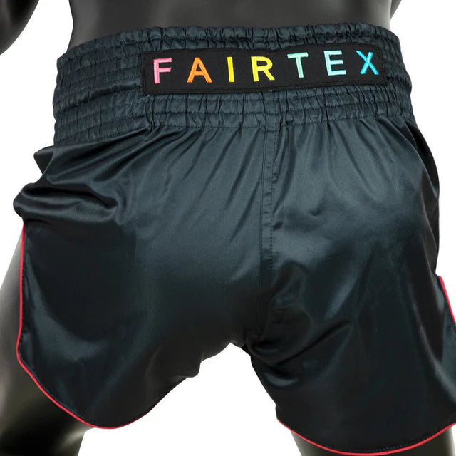 Black Muay Thai shorts with a colorful Fairtex logo on the waistband.