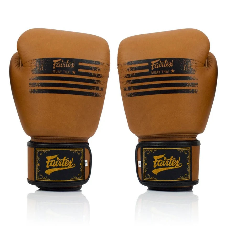 Pair of brown boxing gloves with Fairtex branding on a white background
