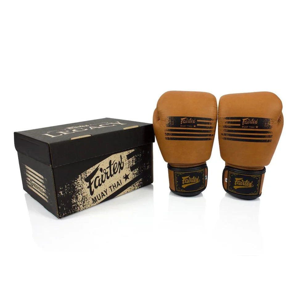 Pair of brown boxing gloves with black accents next to a black Fairtex branded box on a white background