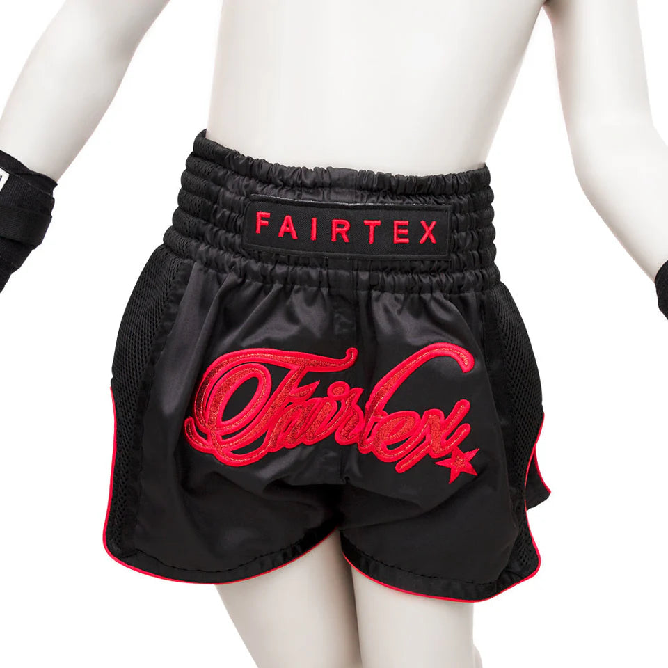 Black boxing shorts with red Fairtex branding on a white background