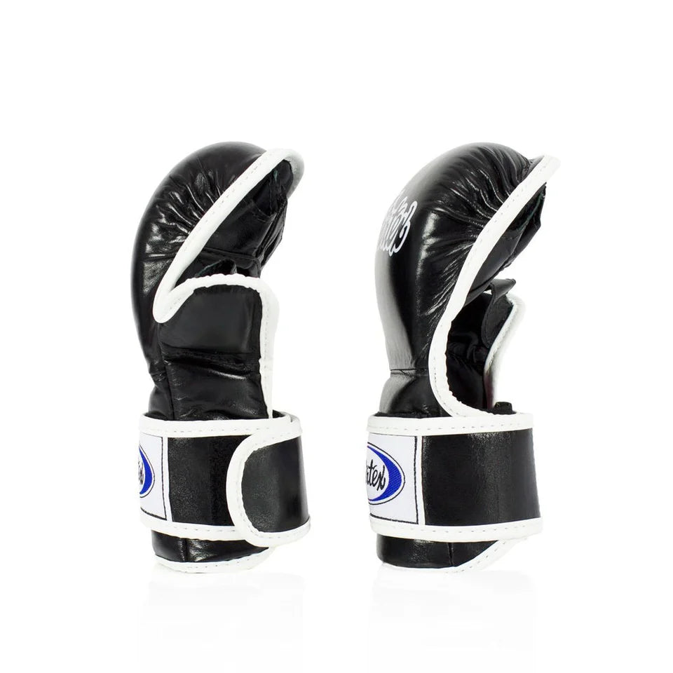 Pair of black MMA sparring gloves with white accents on a white background