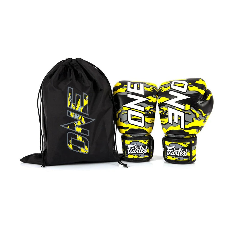 Pair of yellow and black boxing gloves with a matching drawstring bag on a white background