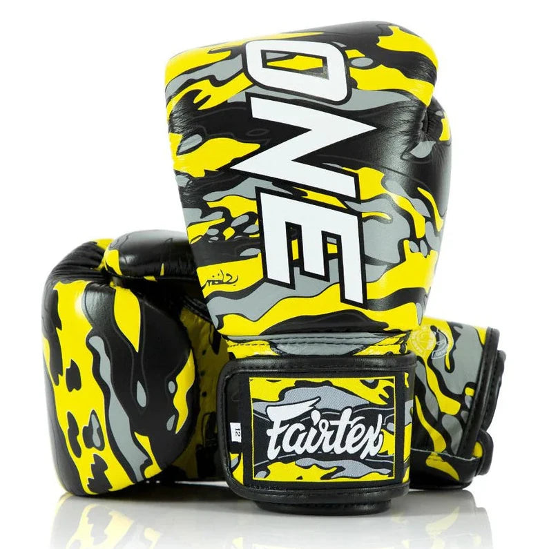 Yellow and black boxing gloves with 'Fairtex' branding on a white background