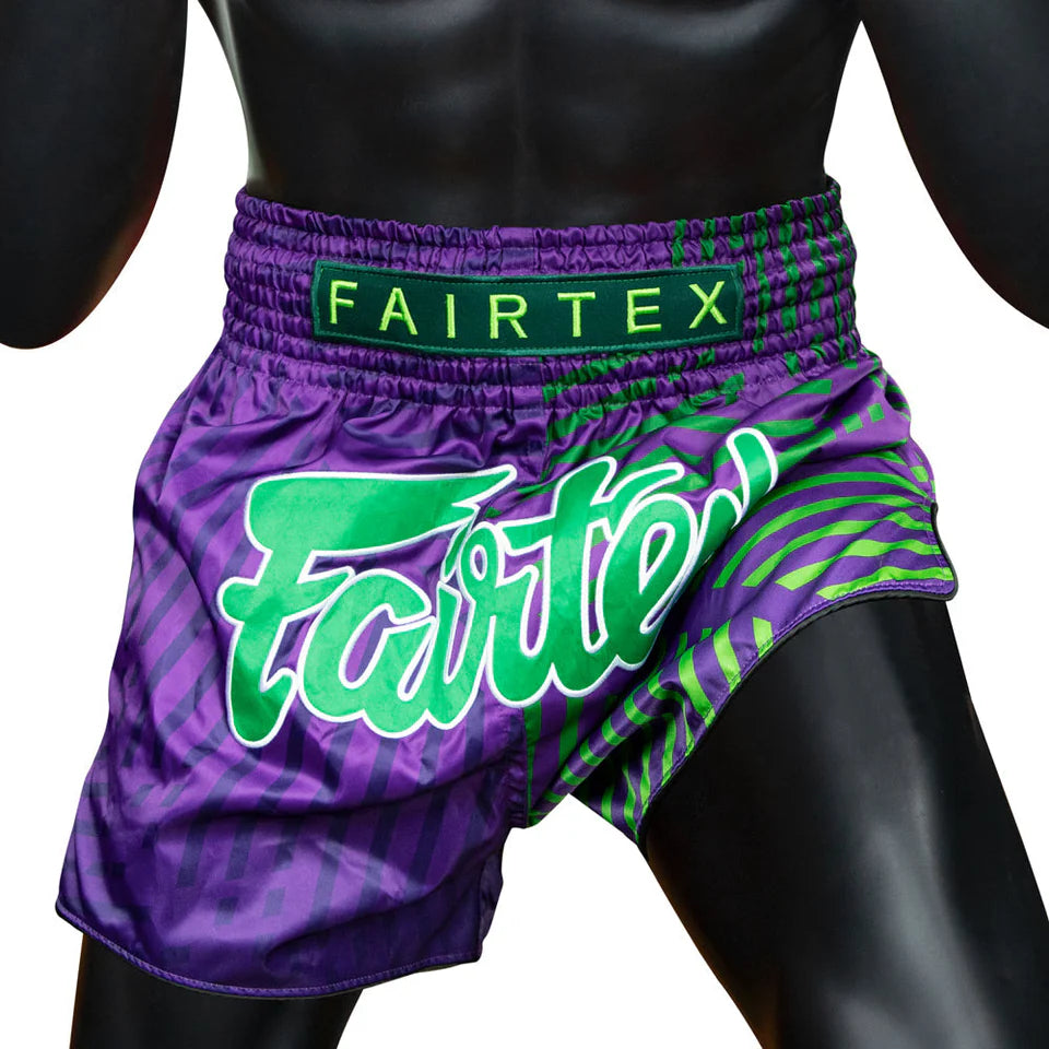 Purple and green Muay Thai fairtex shorts on a mannequin