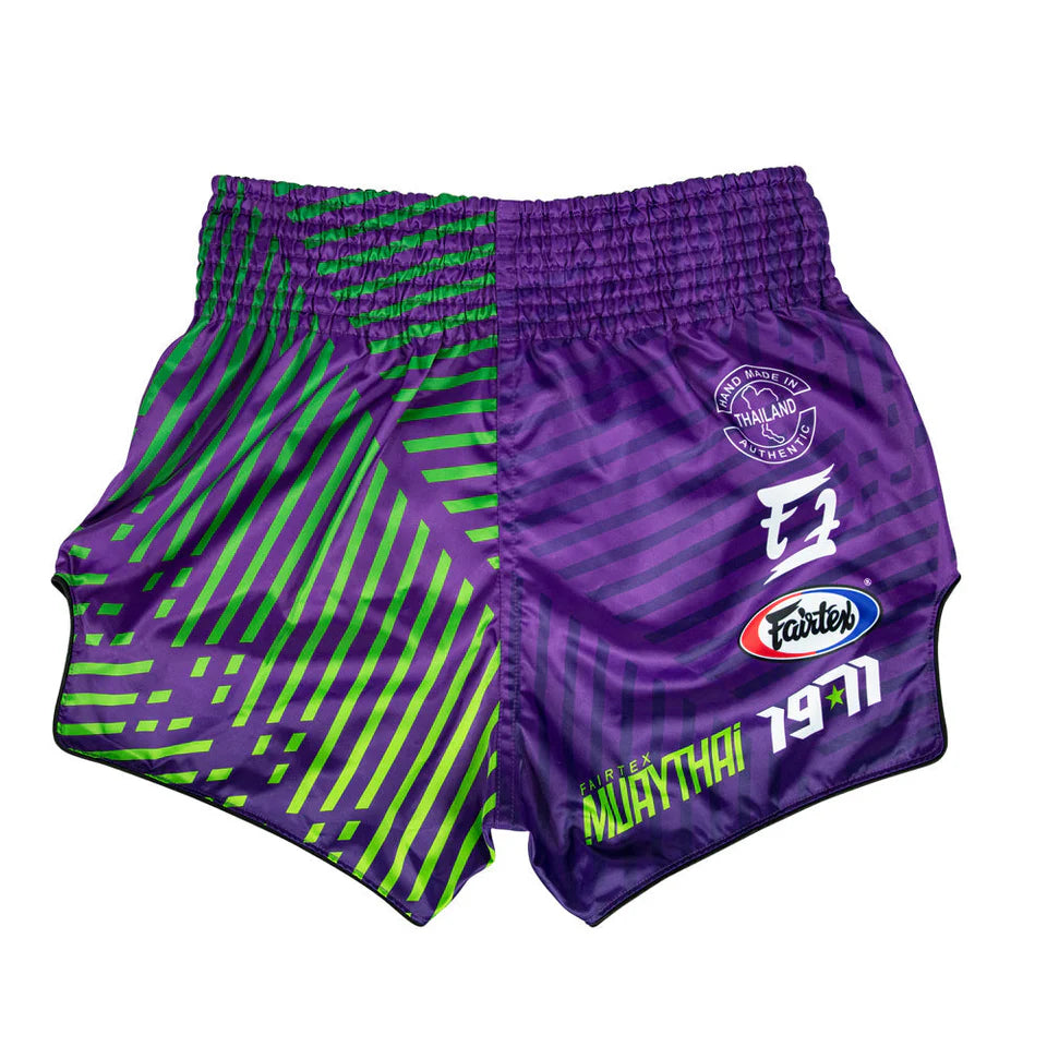 Purple and green boxing shorts with brand logos on a white background