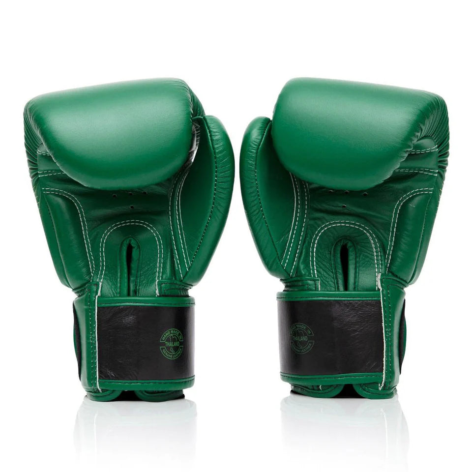Pair of green boxing gloves on a white background