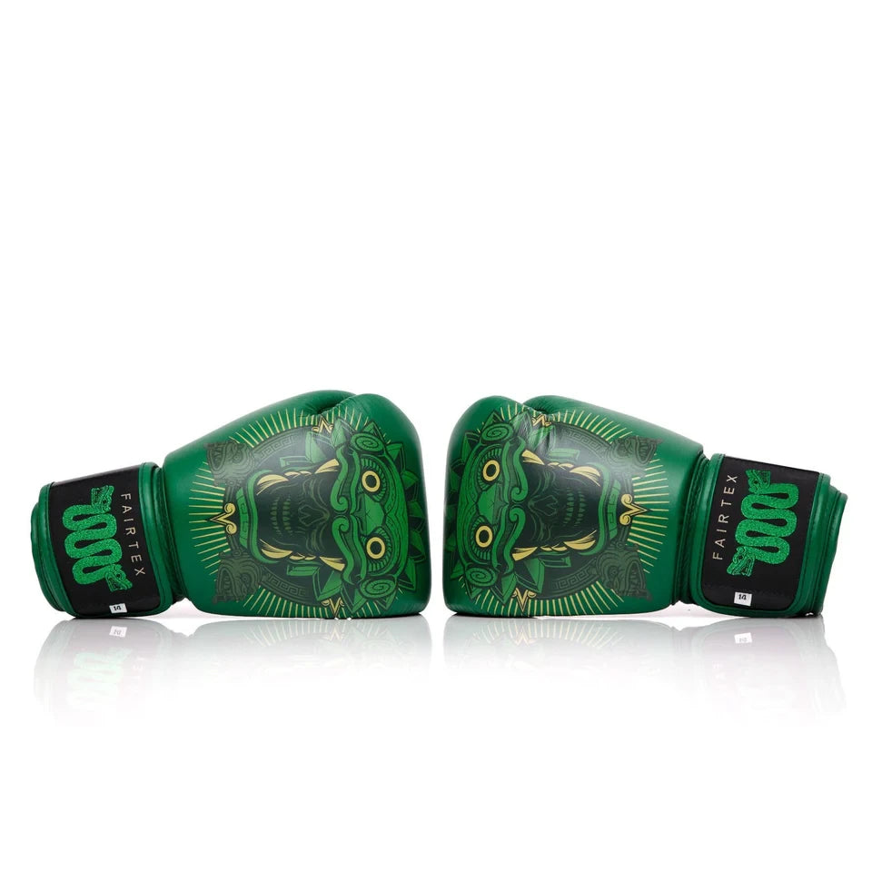 Pair of green boxing gloves with a design on a white background