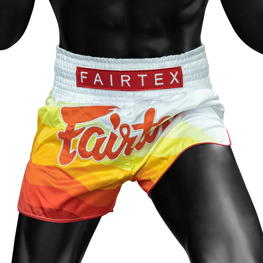 Colorful Muay Thai shorts with Fairtex branding on a plain background