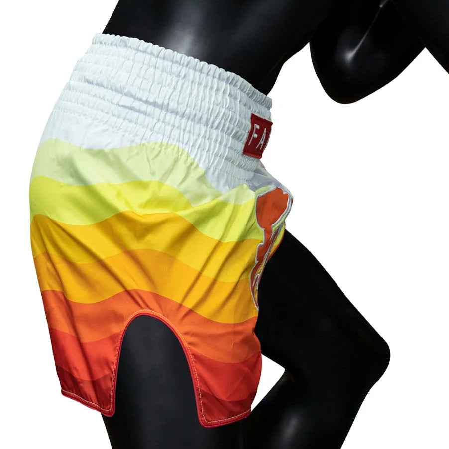 Colorful Muay Thai shorts with a brand logo on a mannequin against a white background
