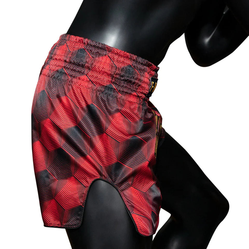 Red and black checkered Muay Thai shorts on a mannequin against a white background