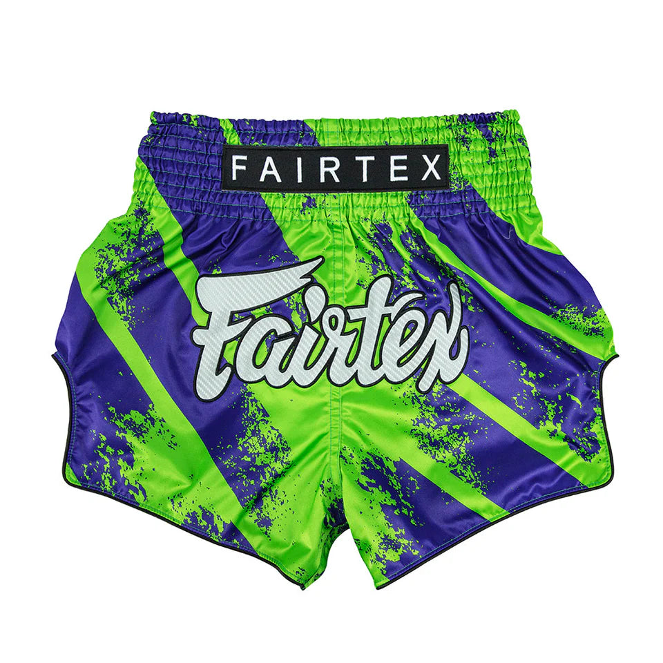 Green and purple boxing shorts with Fairtex branding on a white background
