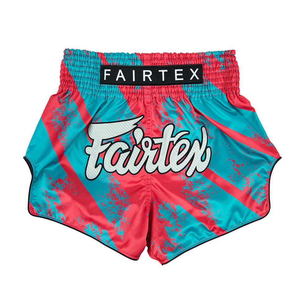 Turquoise and pink Muay Thai shorts with Fairtex branding on a white background