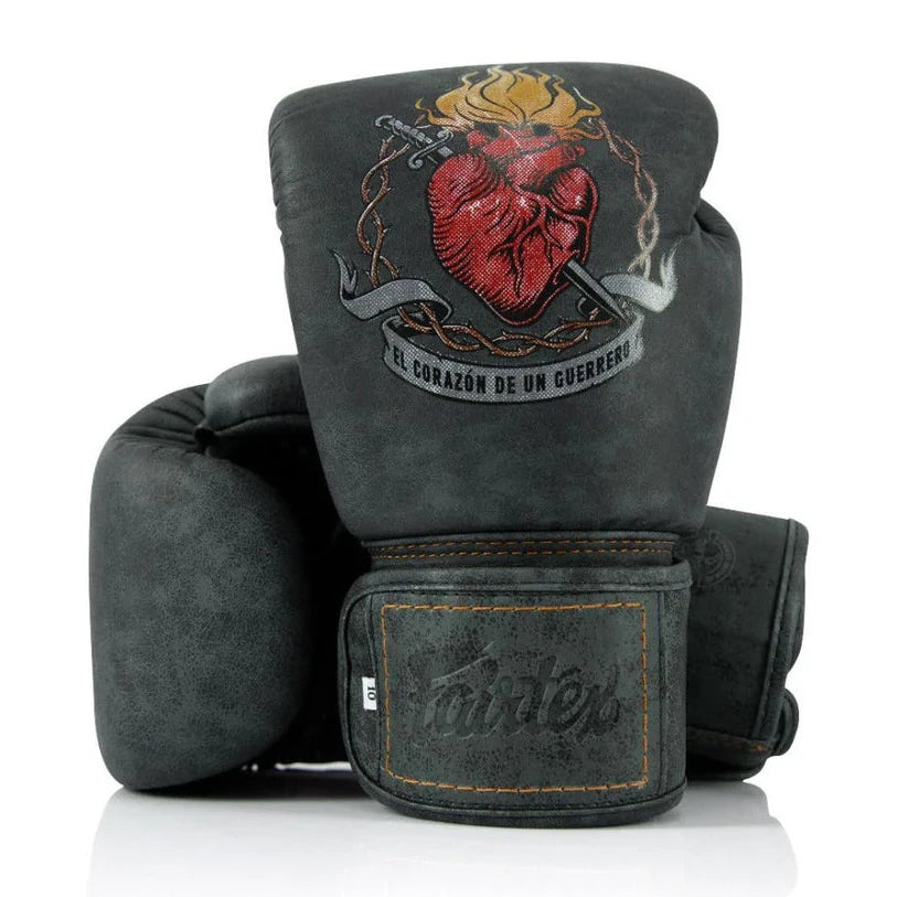 Pair of gray boxing gloves with a heart design and Fairtex logo on a white background