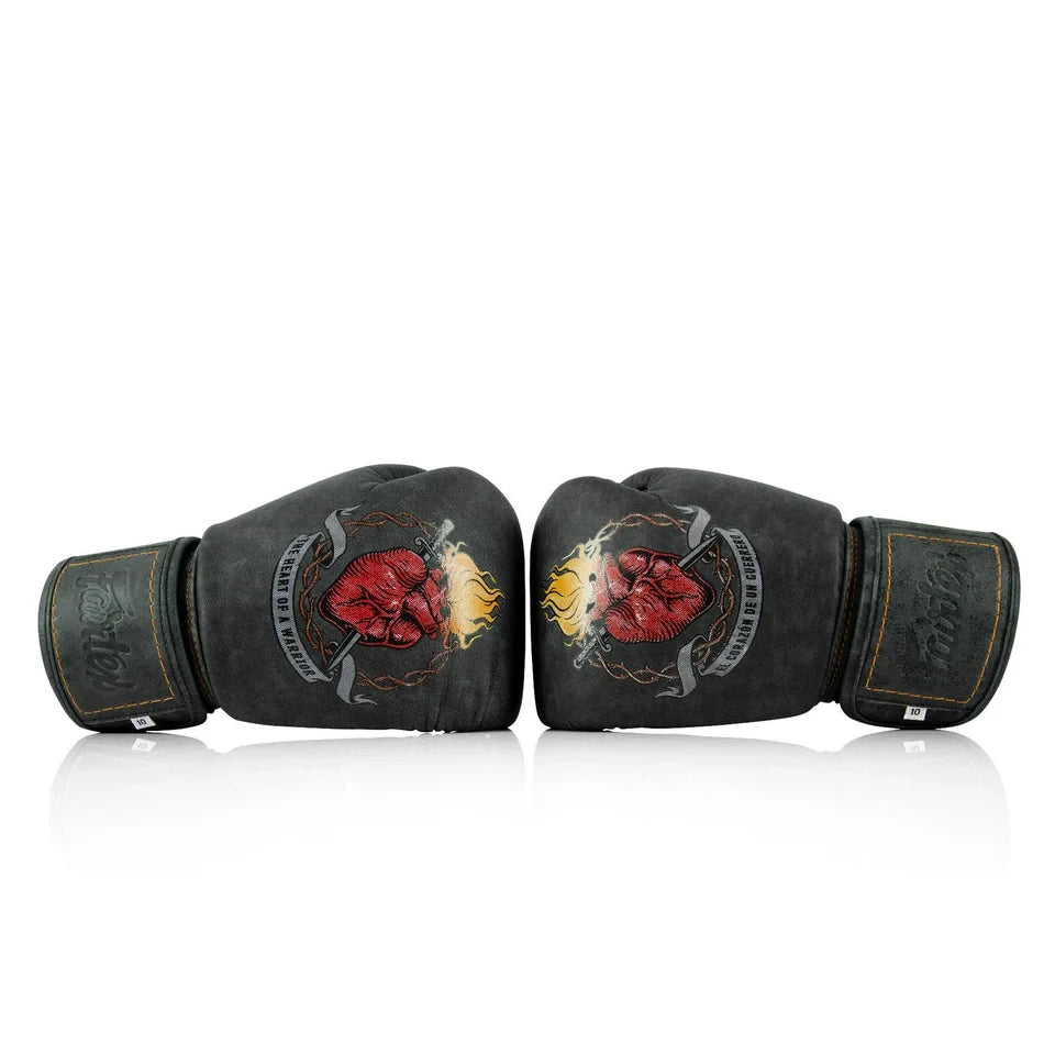 Pair of black boxing gloves with red and yellow design on a white background