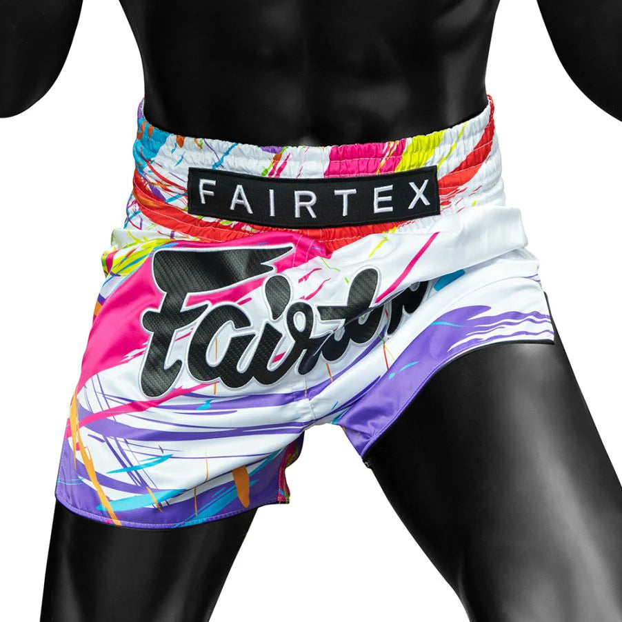 Colorful Muay Thai shorts with Fairtex branding on a black background