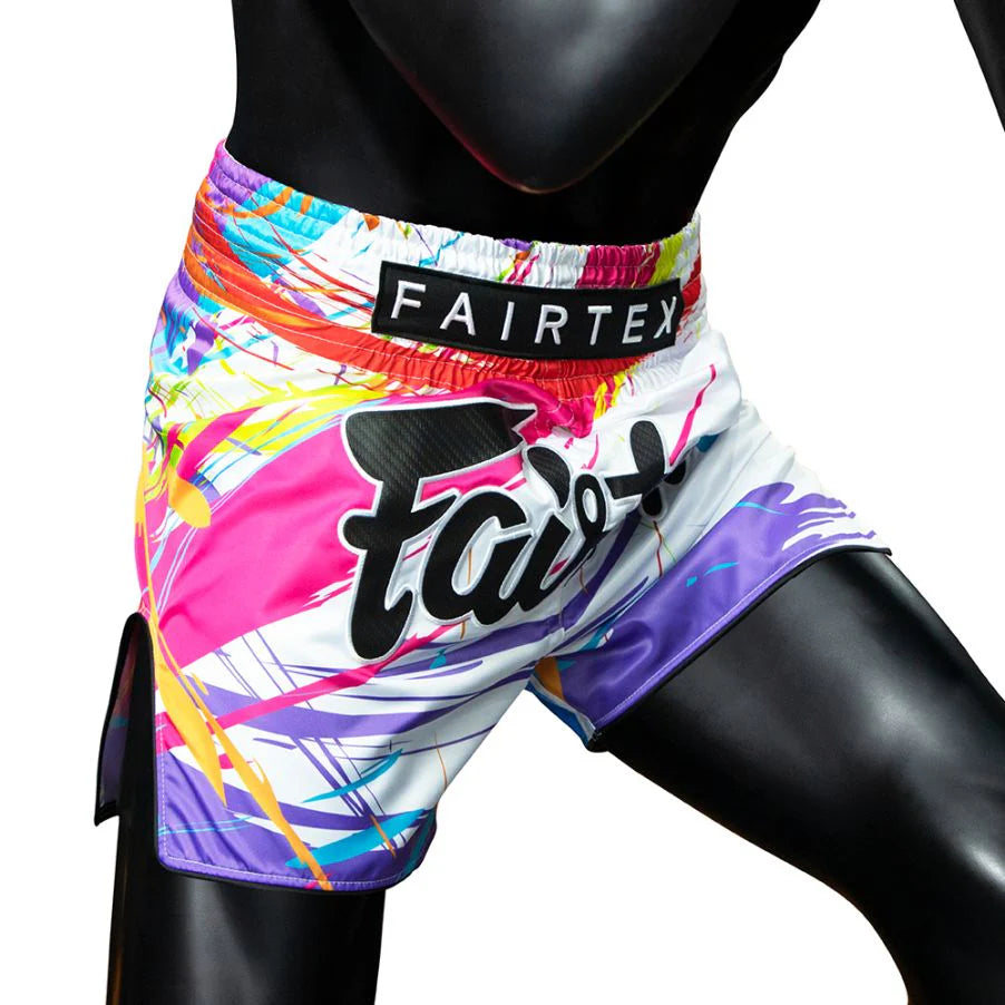 Colorful Muay Thai shorts with 'Fairtex' branding on a white background