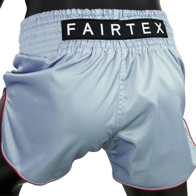 Light blue Muay Thai shorts with a Fairtex waistband on a white background