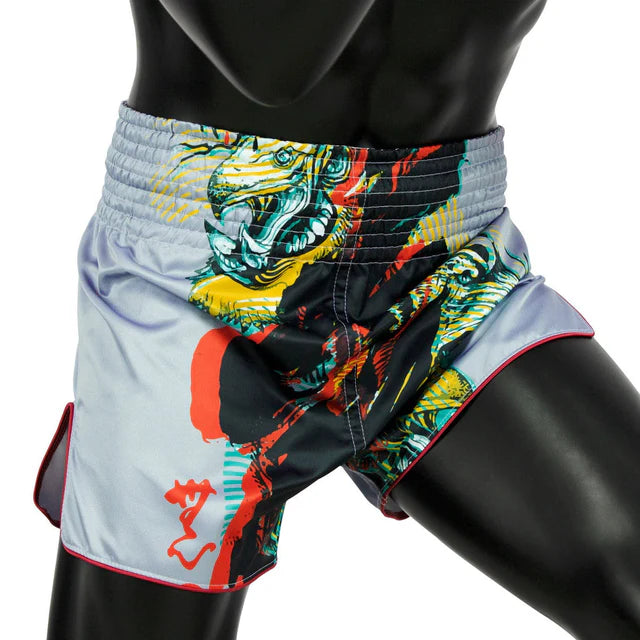 Colorful athletic thai shorts with a tiger design on a mannequin against a white background