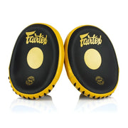 Pair of black and yellow Fairtex focus mitts on a white background