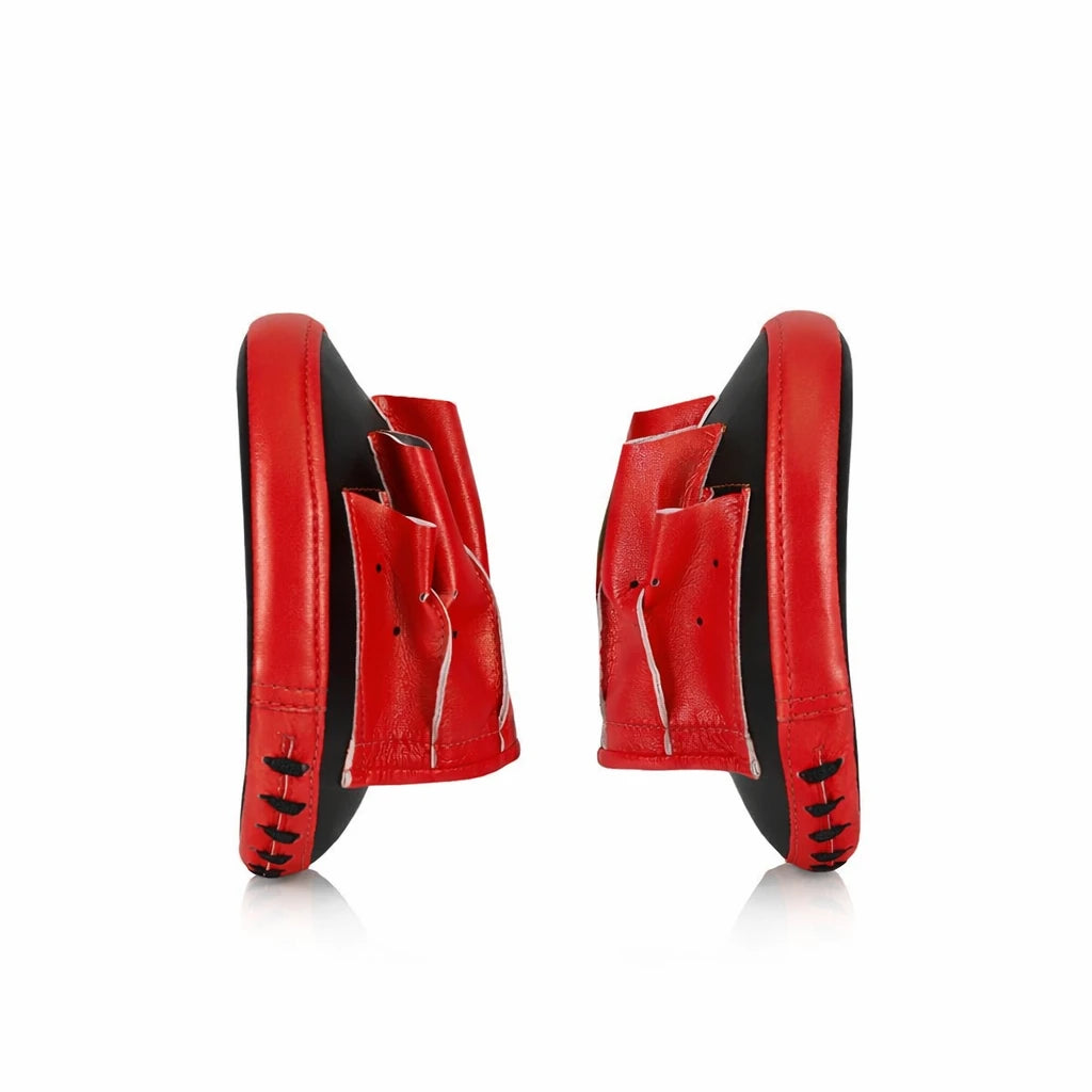 Pair of red and black boxing pads on a white background