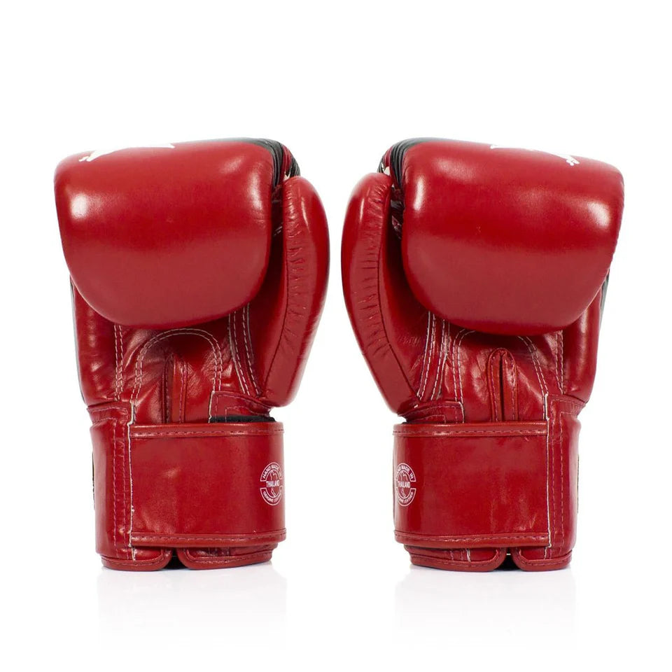 Pair of red boxing gloves on a white background