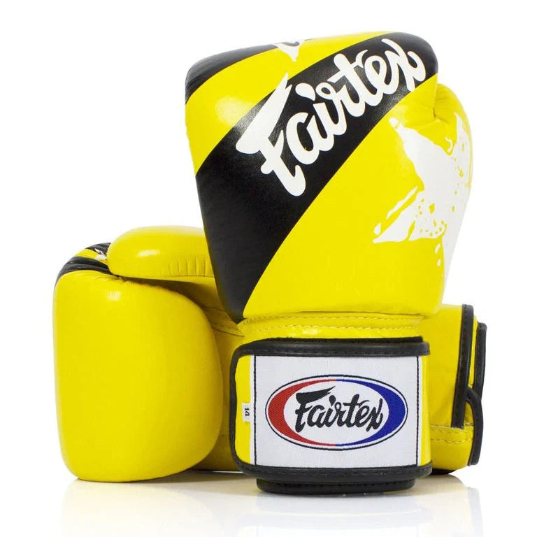 Yellow boxing glove with black and white Fairtex branding on a white background