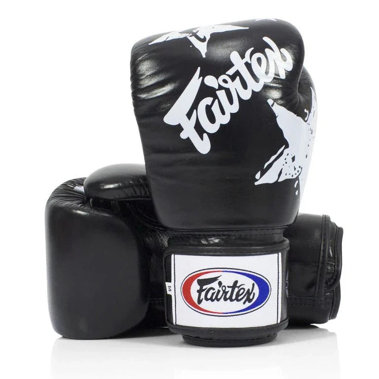 Black boxing gloves with Fairtex logo on a white background