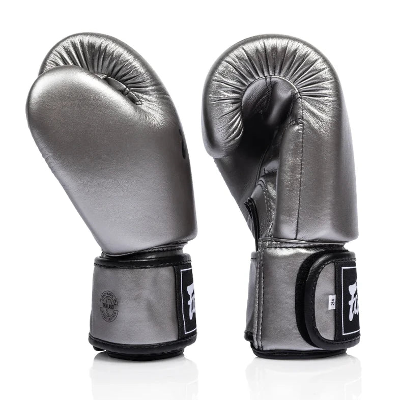 Pair of silver boxing gloves with black accents on a white background