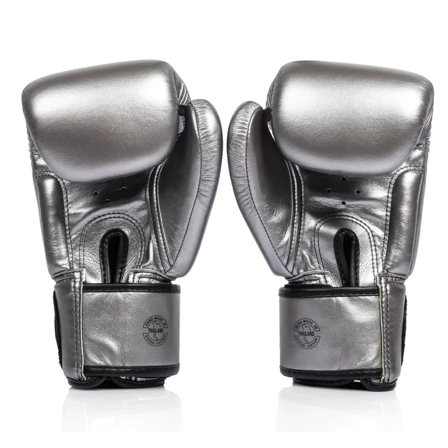 Pair of metallic boxing gloves on a white background