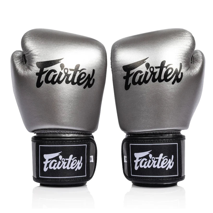 Pair of metallic Fairtex boxing gloves on a white background