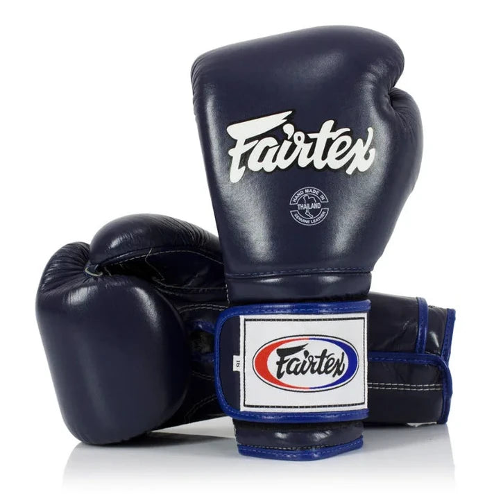 Pair of navy blue Fairtex boxing gloves on a white background
