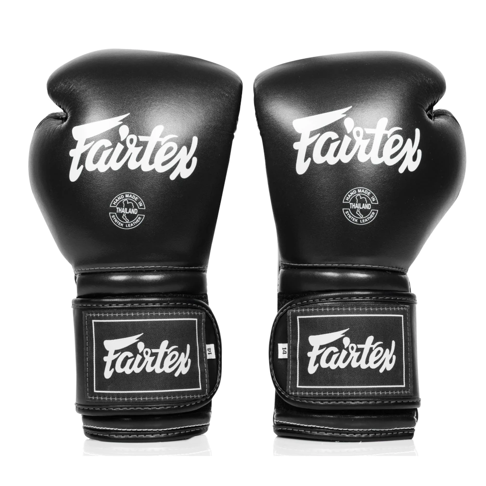Pair of black Fairtex boxing gloves on a white background