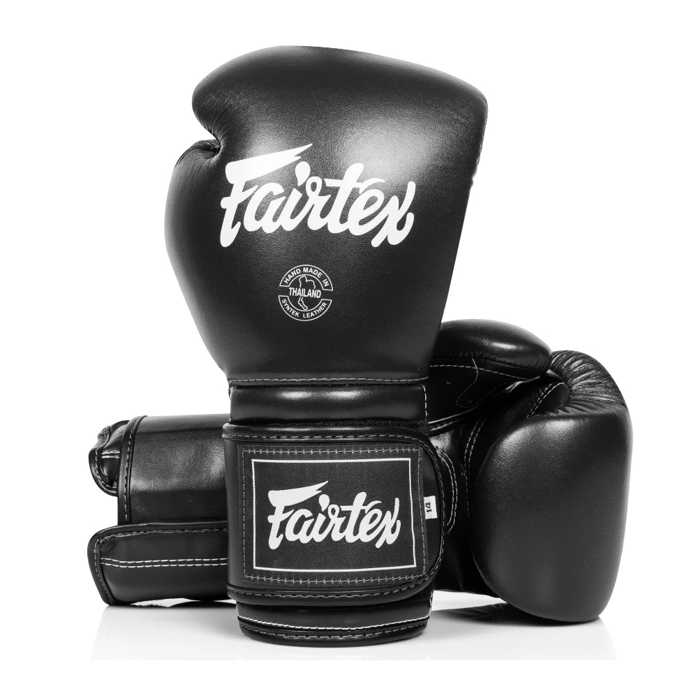 Black boxing gloves with Fairtex logo on a white background
