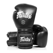 Black boxing gloves with Fairtex logo on a white background