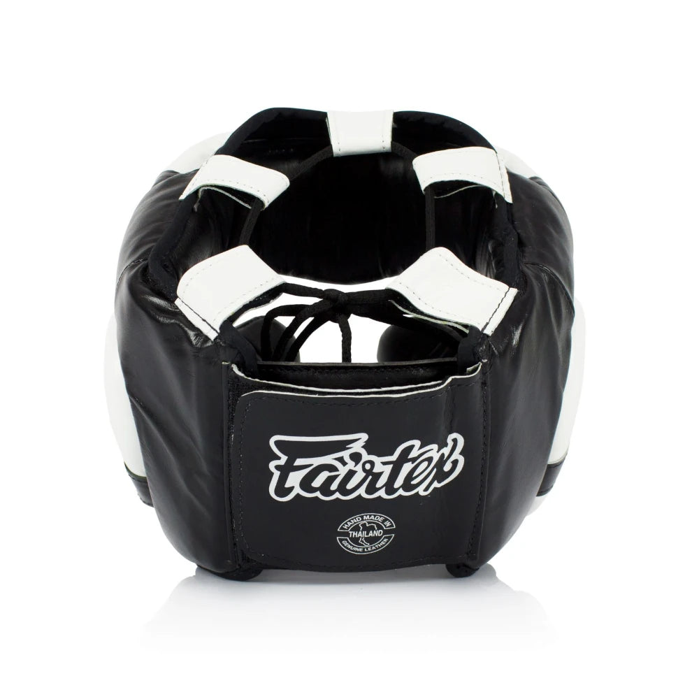 Rear profile of a black and white boxing headgear with 'Fairtex' branding on a white background