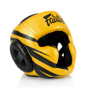 Yellow and black boxing headgear with 'Fairtex' branding on a white background