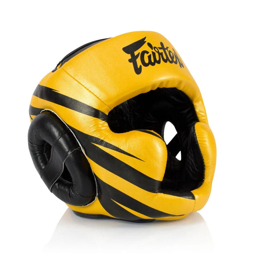 Yellow and black boxing headgear with 'Fairtex' branding on a white background