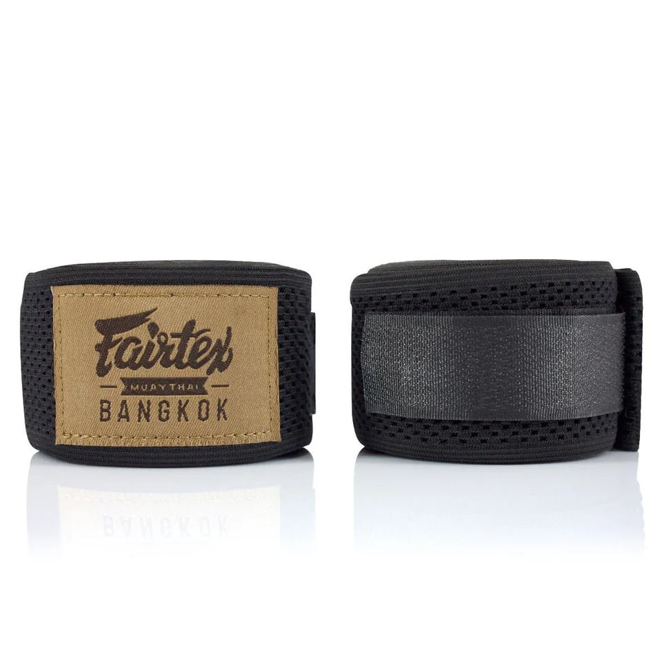 Black boxing hand wraps with Fairtex label on a white background