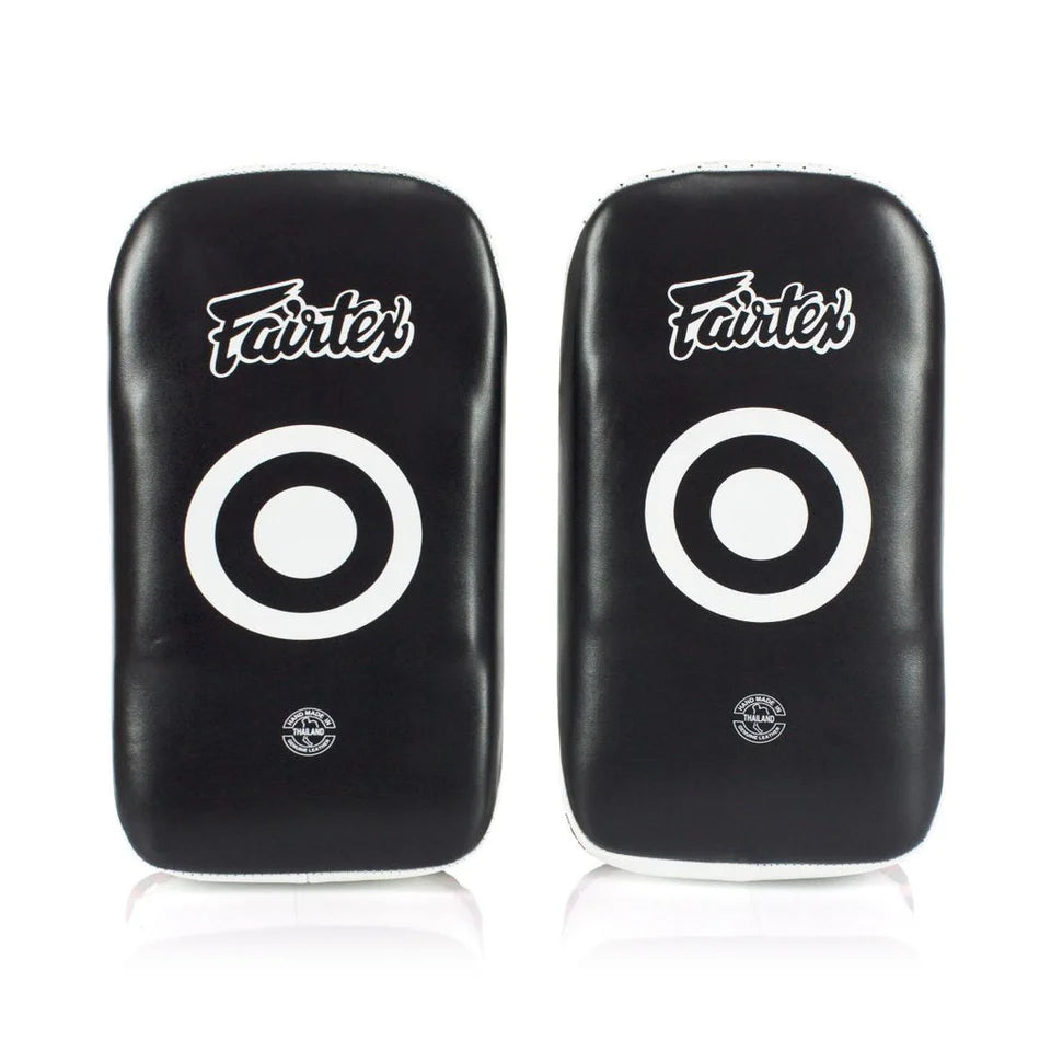 Pair of black Fairtex Muay Thai pads with white circular targets on a white background