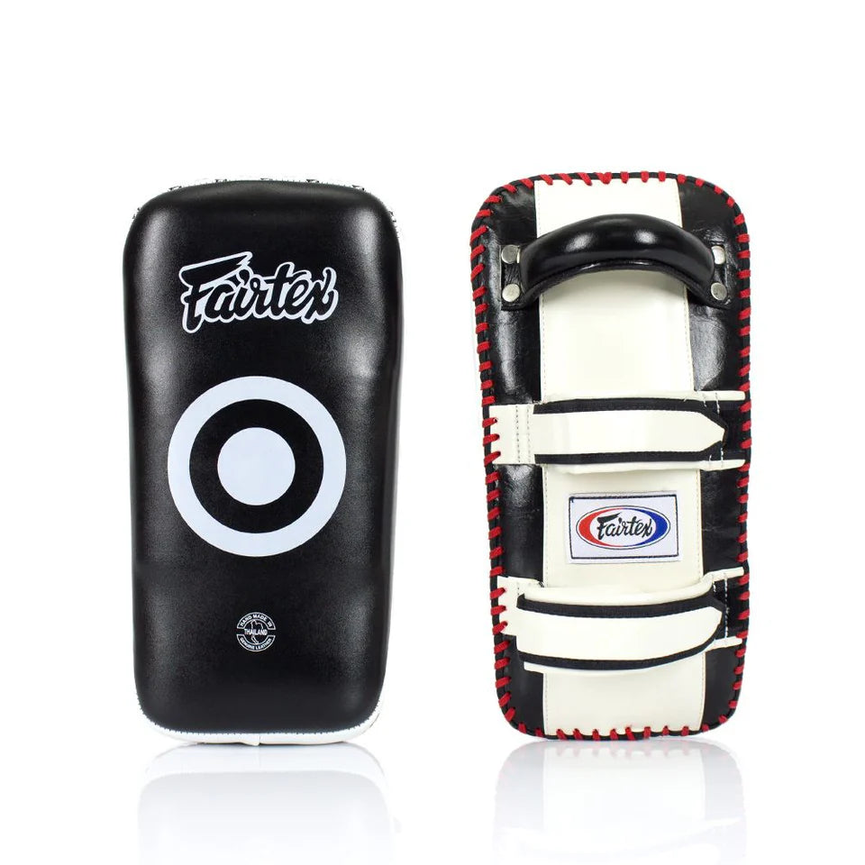 Two Muay Thai pads, one black and one with a red and white design, on a white background.