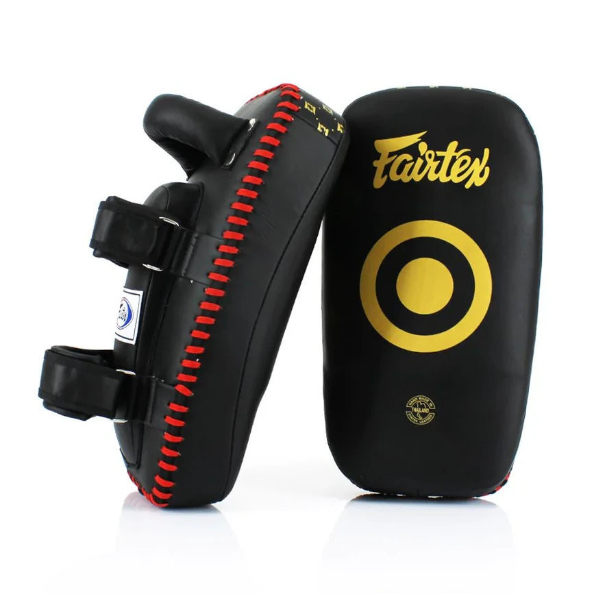 Black Muay Thai pads with red stitching and Fairtex logo on a white background