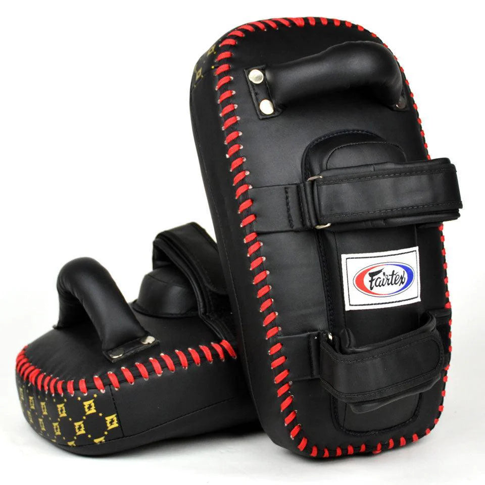 Black Muay Thai pads with red stitching on a white background