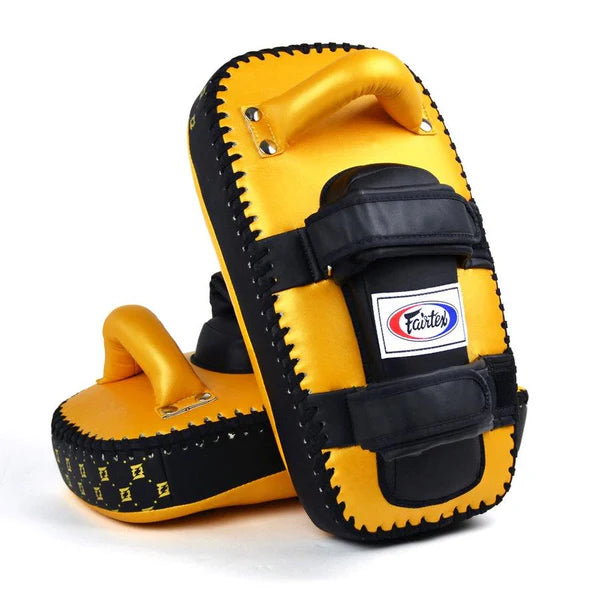 Yellow and black Muay Thai pads with a visible brand logo on a white background