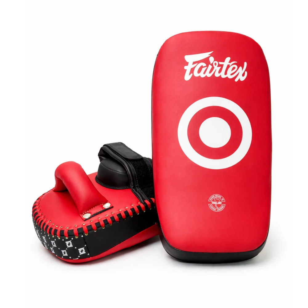 Red Fairtex Muay Thai pads with black accents on a white background