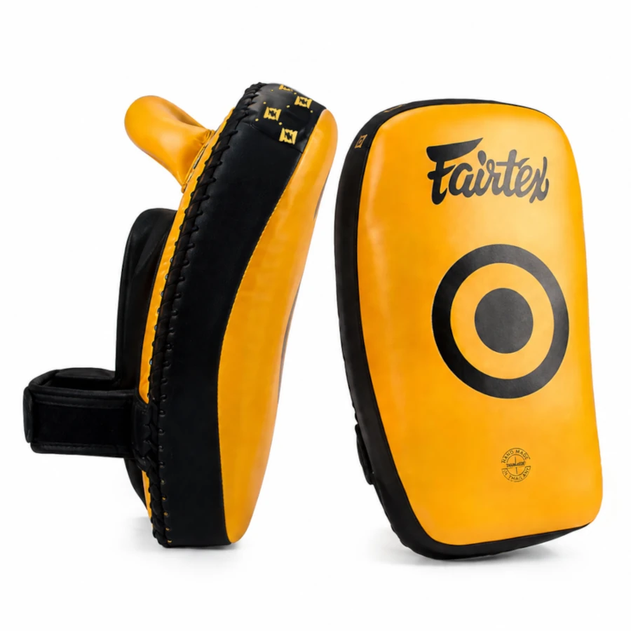 Yellow and black Thai pads with 'Fairtex' branding on a white background