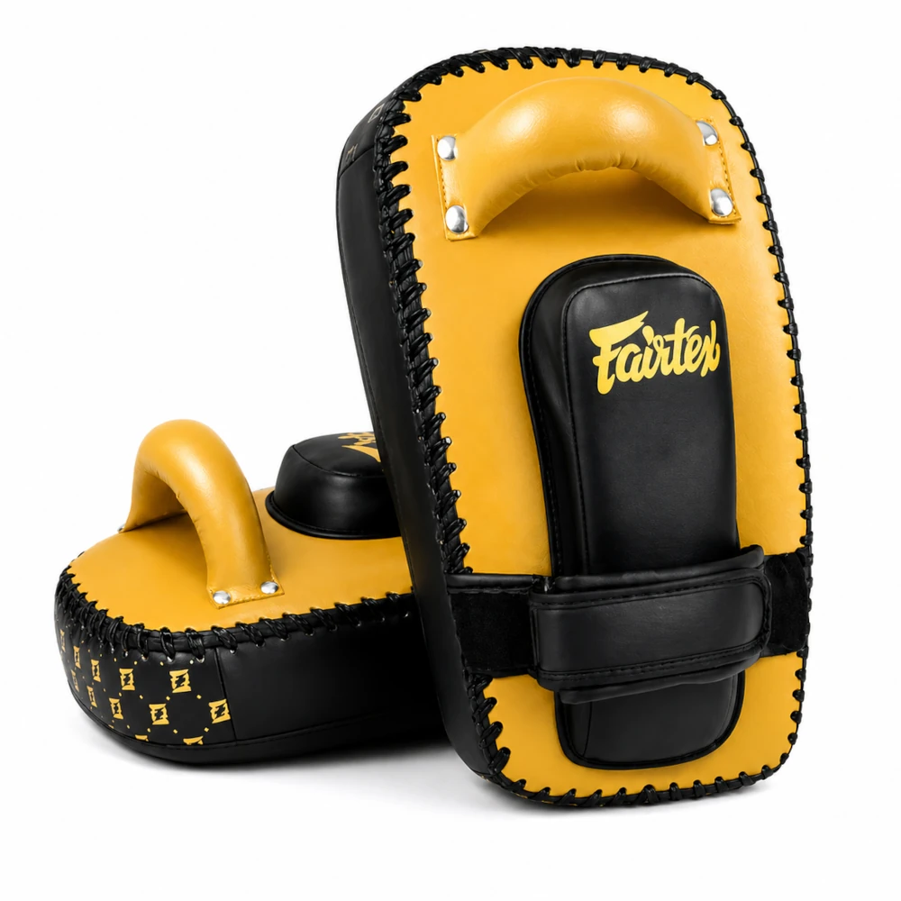 Pair of yellow and black Muay Thai pads with 'Fairtex' branding on a white background.