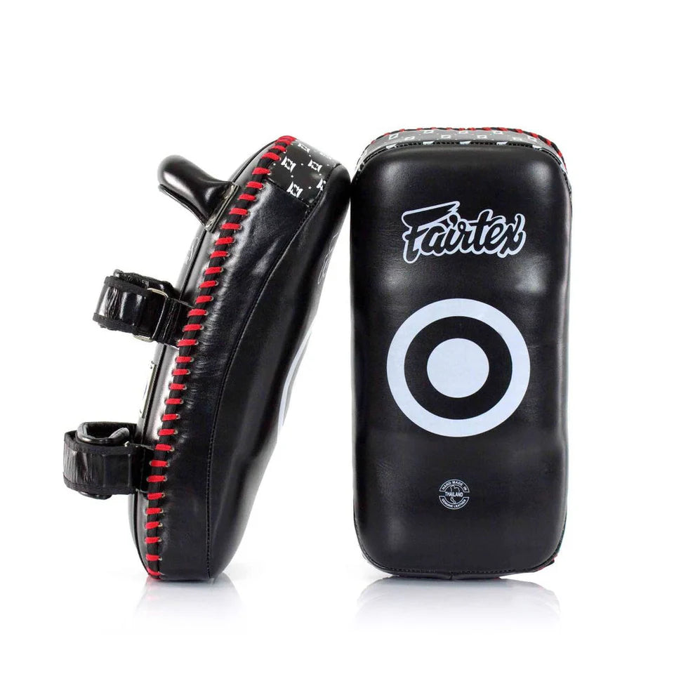Black and red Fairtex Muay Thai pads on a white background