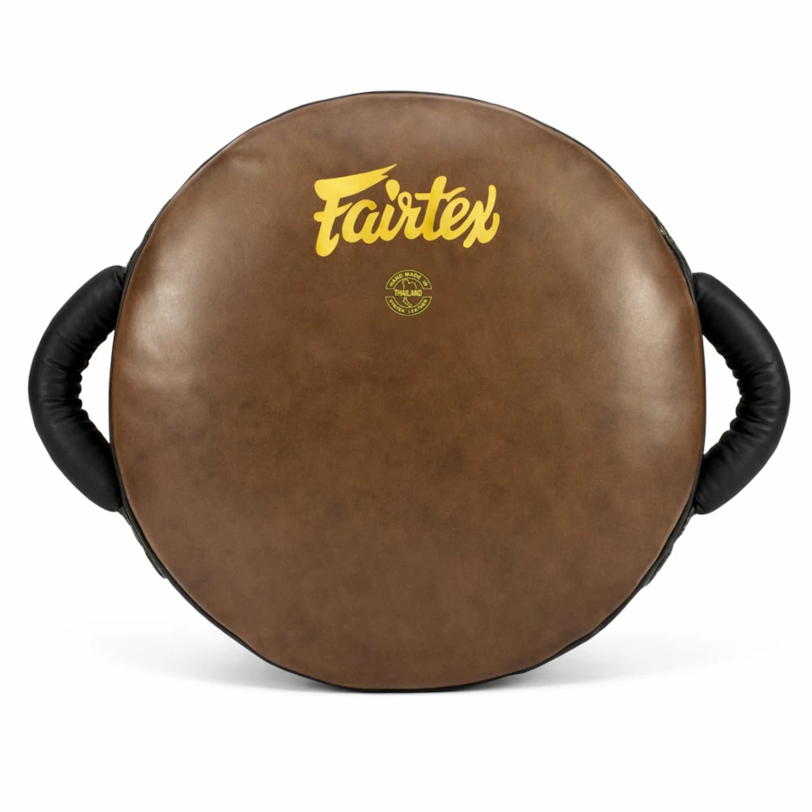 Brown boxing round shield with black handles and Fairtex logo on a white background