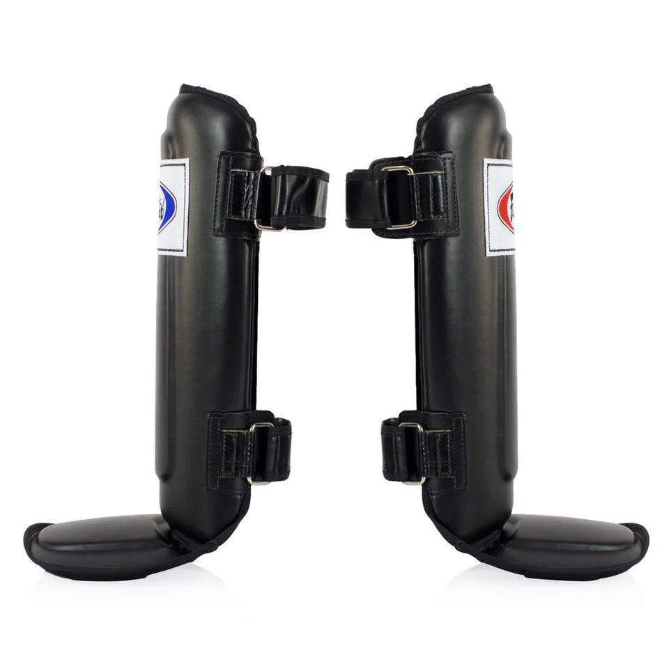 Pair of black shin guards with brand labels on a white background